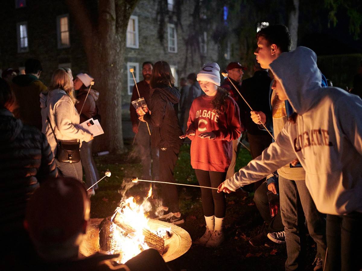 Students gather around a bonfire during a Commons event